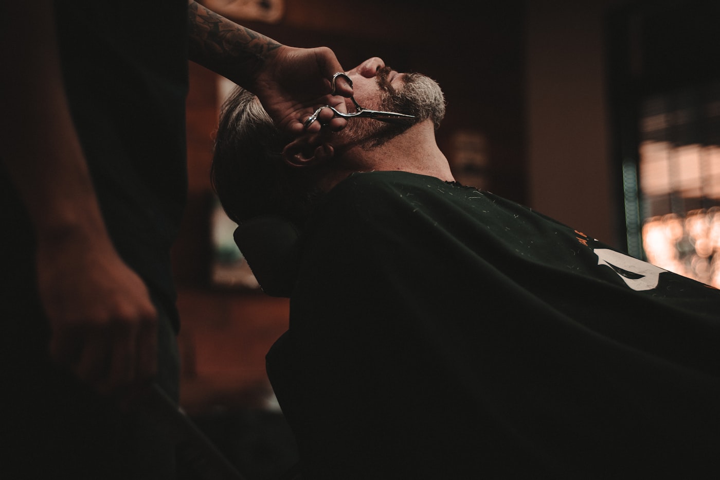 Client reclined in the chair having a foil shave finished with a hot towel
