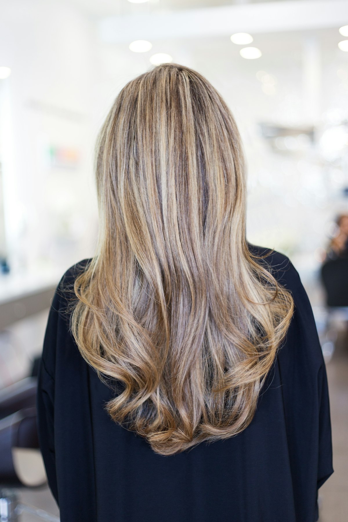 Back view of long blonde lengths after a full bleach and tone service